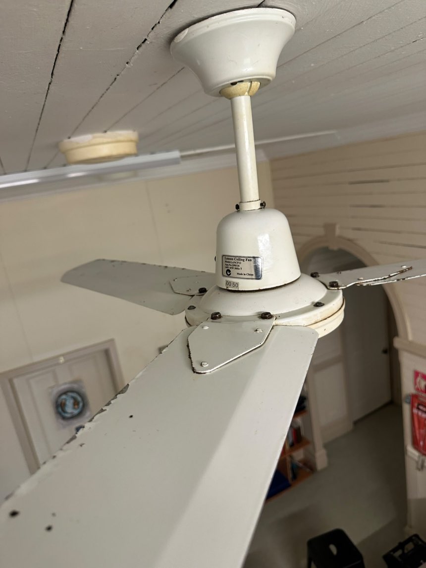The same ceiling fan blades clean after remediation