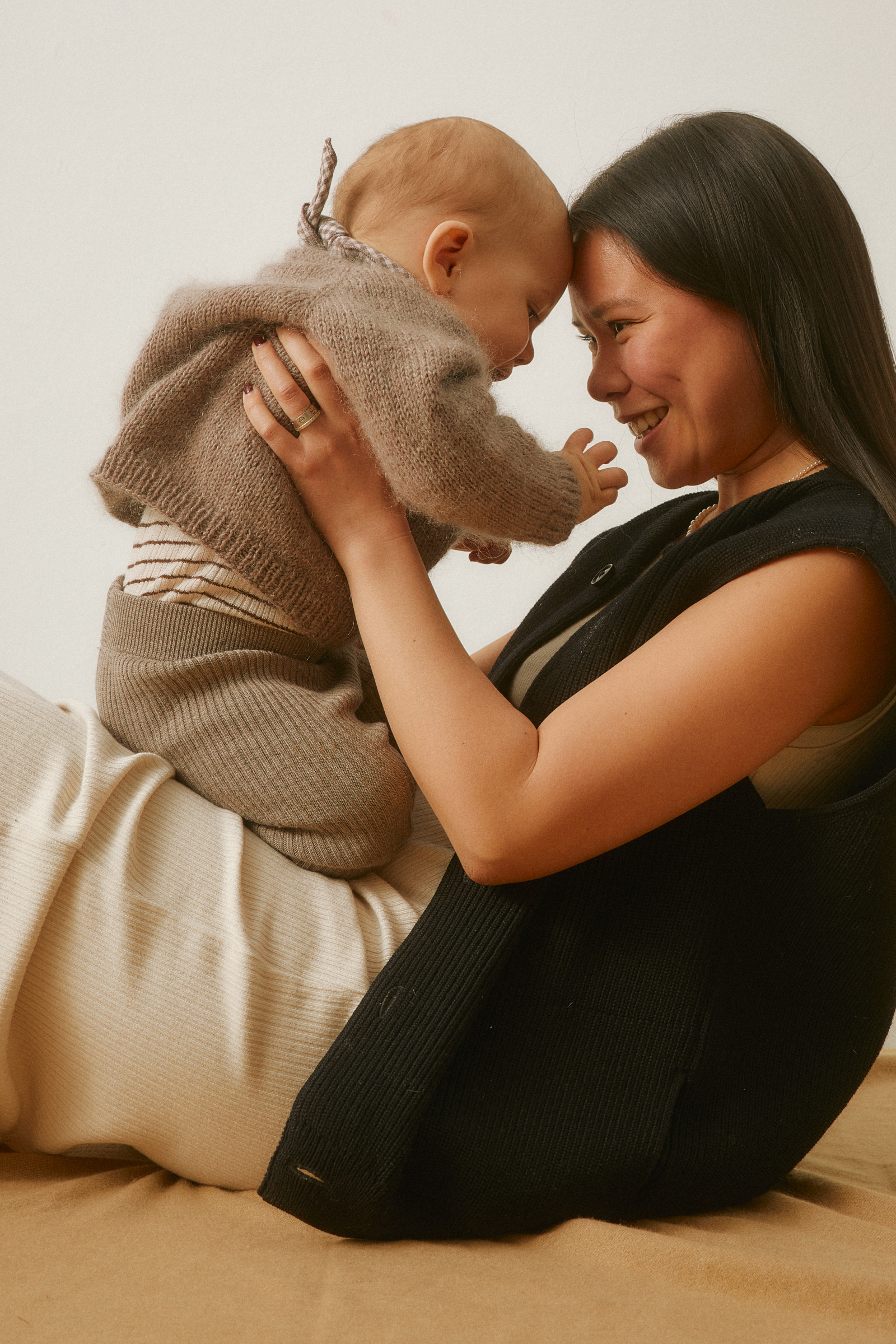 A mother holding her smiling baby in a calm, healthy home
